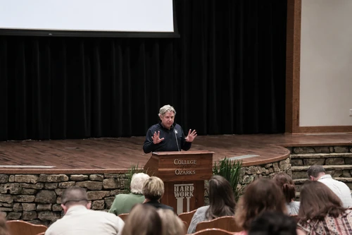 Dr. Brian Polk as he is presenting information a room with other teachers looking at him. 